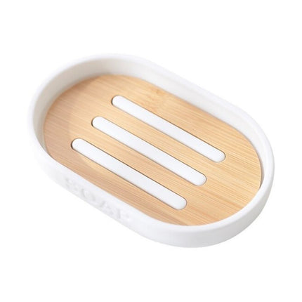 Valkoinen soikea saippua-alusta puuritilällä