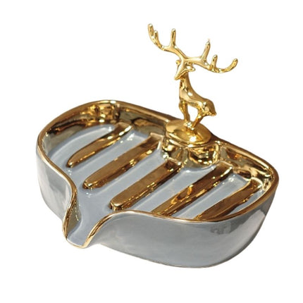 Keraaminen saippua-alusta kultaisella peuralla